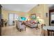 Bright living room with tile flooring, neutral walls, and comfortable seating arrangement for relaxation at 1445 Wilson Rd, Clearwater, FL 33755