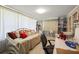 This inviting office space features a comfortable daybed, built-in shelving, and abundant natural light at 1445 Wilson Rd, Clearwater, FL 33755