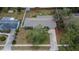 Aerial view shows the home and property with long driveway, nearby homes and mature trees shading the area at 1607 Melodie Dr, Brandon, FL 33510