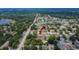 An aerial shot shows the property's location in a neighborhood with mature trees and easy access to amenities at 1607 Melodie Dr, Brandon, FL 33510