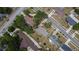 An aerial view displays the neighborhood and the property nestled among other homes and mature trees in the area at 1607 Melodie Dr, Brandon, FL 33510