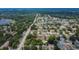 An aerial view showing a home with backyard, mature trees, and neighborhood with access to amenities at 1607 Melodie Dr, Brandon, FL 33510