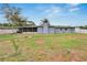 The backyard showcases a fire pit, mature trees, and a well-maintained lawn adjacent to the home's screened-in porch at 1607 Melodie Dr, Brandon, FL 33510
