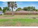 Fenced backyard featuring mature trees and ample space for recreation at 1607 Melodie Dr, Brandon, FL 33510