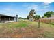 This spacious backyard features a fire pit, mature trees, and a mix of fencing, providing ample space for outdoor enjoyment at 1607 Melodie Dr, Brandon, FL 33510