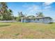 Lush backyard with a covered patio and a white picket fence at 1607 Melodie Dr, Brandon, FL 33510