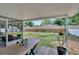 The covered patio with steps down to the fenced-in backyard, perfect for outdoor enjoyment at 1607 Melodie Dr, Brandon, FL 33510