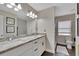 This bathroom boasts double sinks with a marble countertop, white cabinets, and a private toilet area at 1607 Melodie Dr, Brandon, FL 33510