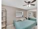 Bedroom with a ceiling fan, exterior views, and ample lighting at 1607 Melodie Dr, Brandon, FL 33510