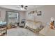 Bedroom with a ceiling fan, crib, and ample lighting at 1607 Melodie Dr, Brandon, FL 33510