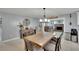 Open dining area adjacent to the living room with rustic table and stylish decor at 1607 Melodie Dr, Brandon, FL 33510