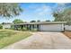 A single-story home featuring an attached two-car garage and well-maintained lawn at 1607 Melodie Dr, Brandon, FL 33510