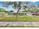 Charming single-story home featuring a well-maintained lawn and mature tree at 1607 Melodie Dr, Brandon, FL 33510