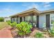 Inviting covered porch with seating and lush landscaping at 1607 Melodie Dr, Brandon, FL 33510
