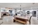 Open-concept kitchen and dining area with a farmhouse table and white cabinets at 1607 Melodie Dr, Brandon, FL 33510