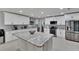 Bright kitchen features white cabinetry, modern appliances, and a center island at 1607 Melodie Dr, Brandon, FL 33510