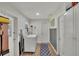 A clean, well-lit laundry room with washer, dryer, and storage space at 1607 Melodie Dr, Brandon, FL 33510