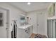 Functional laundry area with white washer and dryer, plus ample storage at 1607 Melodie Dr, Brandon, FL 33510