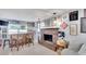 Comfortable living room boasts a brick fireplace, wood bar with stools, and curated wall art at 1607 Melodie Dr, Brandon, FL 33510
