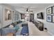 Comfortable living room with a gray sectional sofa, built-in bookshelves, and a flat screen TV at 1607 Melodie Dr, Brandon, FL 33510
