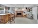 Cozy living room boasts a brick fireplace, wood bar with stools, and curated wall art at 1607 Melodie Dr, Brandon, FL 33510