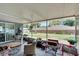 A covered patio offers shade and overlooks a well-maintained backyard with mature landscaping at 1607 Melodie Dr, Brandon, FL 33510