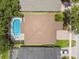 Aerial view of a home featuring a screened in pool and lush mature trees at 16206 Nottingham Park Way, Tampa, FL 33647