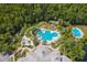 Aerial view of the resort-style pool with slide, surrounded by lush greenery, offers a refreshing oasis within the community at 16206 Nottingham Park Way, Tampa, FL 33647