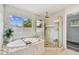 Relaxing bathroom featuring a soaking tub with window, and a shower with glass door at 16206 Nottingham Park Way, Tampa, FL 33647