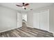 Bedroom featuring stylish floors, neutral walls, a ceiling fan, double closets, and an ensuite bathroom at 16206 Nottingham Park Way, Tampa, FL 33647