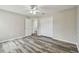 Comfortable bedroom featuring stylish floors, neutral walls, a ceiling fan, and an ensuite bathroom at 16206 Nottingham Park Way, Tampa, FL 33647