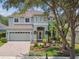 Elegant two-story home with attached garage and lush landscaping offering curb appeal at 16206 Nottingham Park Way, Tampa, FL 33647