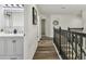 Upstairs hall view featuring bathroom and staircase with black metal railing at 16206 Nottingham Park Way, Tampa, FL 33647