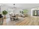 Bright and airy living space features wood floors, a dining table, and comfortable seating at 16206 Nottingham Park Way, Tampa, FL 33647