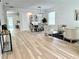 Open-concept living area with beautiful floors, dining set, and stylish seating arrangement at 16206 Nottingham Park Way, Tampa, FL 33647