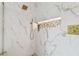 Walk-in shower boasts marble tile, a rainfall showerhead, a handheld sprayer, and a stylish stone accent niche at 16206 Nottingham Park Way, Tampa, FL 33647
