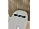 Close-up of modern toilet with lighted display panel and wood slat accent wall at 16206 Nottingham Park Way, Tampa, FL 33647