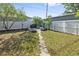 Backyard with a built-in grill and white privacy fence at 2002 Waikiki Way, Tampa, FL 33619