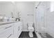Modern bathroom featuring sleek cabinetry, stone countertops, and a glass-enclosed shower for contemporary appeal at 2002 Waikiki Way, Tampa, FL 33619