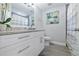 Well-lit bathroom featuring a granite countertop, sleek cabinetry, and a decorative mirror for enhanced appeal at 2002 Waikiki Way, Tampa, FL 33619