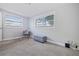 Bright bedroom with two windows, chair, and ottoman, creating a cozy and inviting space at 2002 Waikiki Way, Tampa, FL 33619