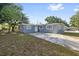 Charming single-story home featuring a well-manicured lawn and a long driveway leading to the residence at 2002 Waikiki Way, Tampa, FL 33619