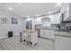 Modern kitchen equipped with stainless steel appliances, white cabinetry, and a functional island to facilitate cooking at 2002 Waikiki Way, Tampa, FL 33619