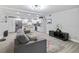 Open-concept living room featuring an integrated kitchen and a comfortable couch to create a relaxed environment at 2002 Waikiki Way, Tampa, FL 33619
