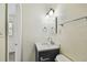 Bathroom with a dark vanity, marble countertop, and modern fixtures at 208 Danube Ave # 101, Tampa, FL 33606