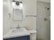 A bathroom featuring a dark vanity with marble countertop, a shower, and modern lighting fixtures at 208 Danube Ave # 101, Tampa, FL 33606