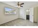 Bedroom with ceiling fan, large window, and ensuite bathroom at 208 Danube Ave # 101, Tampa, FL 33606