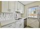 Charming kitchen with white cabinets and stainless steel appliances at 208 Danube Ave # 101, Tampa, FL 33606