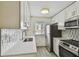 Updated kitchen with stainless steel appliances, tiled backsplash, and ample cabinet space at 208 Danube Ave # 101, Tampa, FL 33606