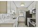 Updated kitchen featuring stainless steel appliances and marble-patterned tile backsplash at 208 Danube Ave # 101, Tampa, FL 33606